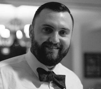 a man wearing a bow tie looking at the camera