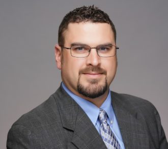 a man wearing glasses posing for the camera